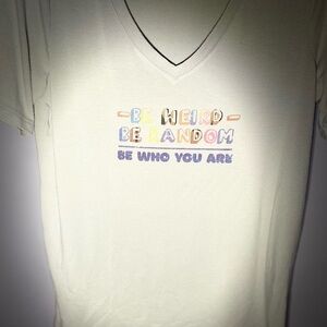 Green tee shirt that says “be weird be random be who you are”